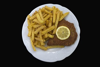Cordon bleu with french fries on a black background
