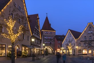 Christmas illuminated market place with the historic Hersbrucker Tor in the evening