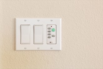 Light switches and fan control on wall of home