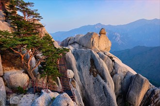 View of stones and rock formations from Ulsanbawi rock peak on sunset with staircase. Seoraksan National Park