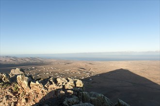 Mountain shadow in the shape of a triangle in the landscape