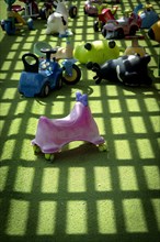 Plastic vehicle toys on green lawn