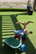 Plastic vehicle toys on green lawn