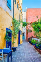 Street cafe in scenic picturesque streets of Chania venetian town with coloful old houses. Chania greek village in the morning. Chanica