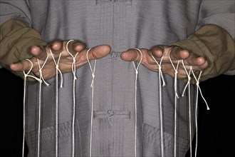 String-pulling puppeteer with Chinese shirt