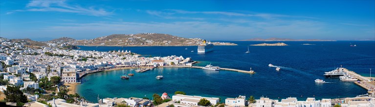 Panorama of Mykonos town Greek tourist holiday vacation destination with famous windmills