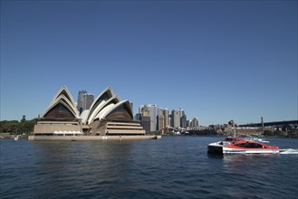 Sydney Opera House with a tourist boat going past