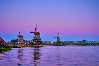 Windmills at famous tourist site Zaanse Schans in Holland in twilight after sunset. Zaandam