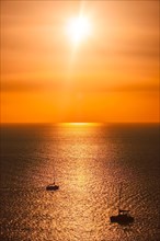 Yacht boats silhouettes in Aegean sea on sunset. Mykonos