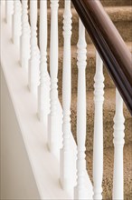 Stair railing and steps with carpet in house