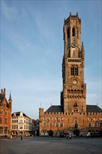 Brugge Belfry tower famous tourist destination and Grote markt square in Bruges