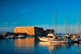 Venetian Fort Venetian fortress of Koules Castello a Mare castle in Heraklion and moored Greek fishing boats in port