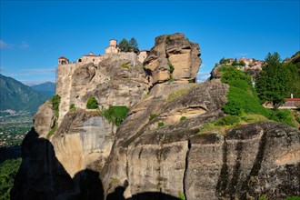 Monastery of Varlaam and Monastery of Great Meteoron in famous greek tourist destination Meteora in Greece on sunrise with scenic scenery landscape