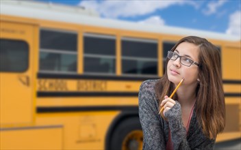 Young female student near school bus