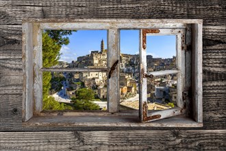 View through a rustic wooden window on Matera