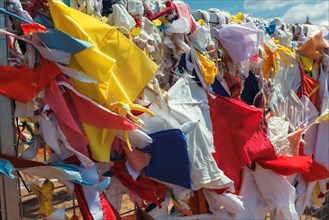 Multicolored fabric rags flags in Buddhist temple and pilgrimage site Ruwanweliseya Dagoba