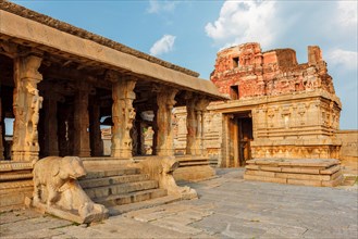 Pillared porch in Krishna Temple and gopura tower. Hampi