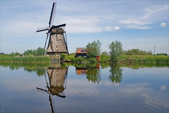 Historic windmill reflected in a canal
