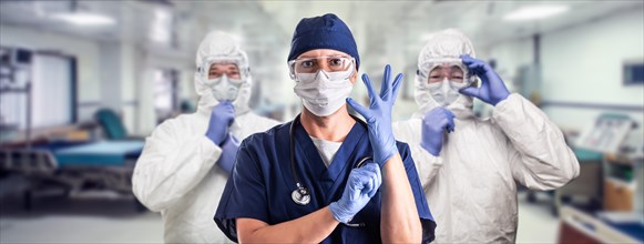 Team of female and male doctors or nurses wearing personal protective equipment in hospital emergency room