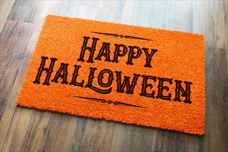 Happy halloween orange welcome mat on wood floor background