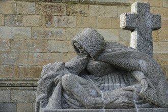 Modern granite Pieta in front of the Gothic cathedral of Saint-Paul Aurelien