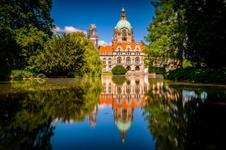 The new city hall of Hannover with the Maschpark and the Maschteich in the foreground with reflection in the water