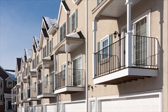 Row of apartment condominiums balconies and garage doors
