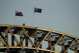 Flags on the Sydney Harbour Bridge at sunrise