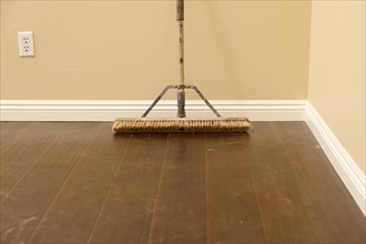 Push broom on a newly installed laminate floor and new baseboards