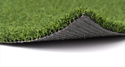 Flipped up section of artificial turf grass on white background