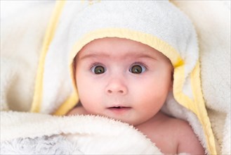 Cute baby girl after bath wrapped in towel. Hygiene and health care concept of new born