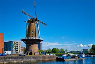 View of the harbour of Delfshaven with the old grain mill known as De Destilleerketel. Rotterdam