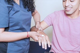 Physiotherapist with patient wrist assessment