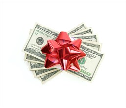 Stack of money with bow isolated on a white background