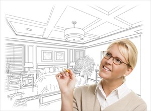 Creative woman with pencil over custom bedroom design drawing on white