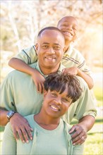 Beautiful happy african american family portrait outdoors at the park