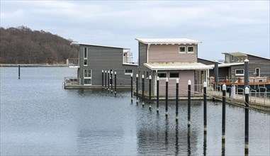 Pile dwellings as holiday homes with boat mooring