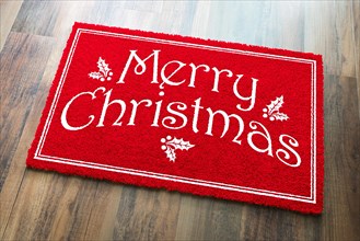 Merry christmas red welcome mat on wood floor background