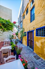 Street cafe in scenic picturesque streets of Chania venetian town with coloful old houses. Chania greek village in the morning. Chanica