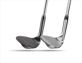 Chrome and black golf club wedge irons on white background