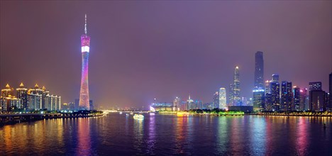 Guangzhou cityscape skyline ver the Pearl River illuminated in the evening panorama