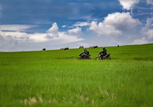 Young man on his motorcycle traveling through the countryside with copy space