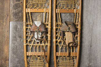 Antique snowshoes on rustic cabin wall