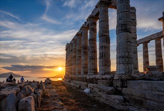 Cape Sounio sunset at Sounion with ruins of the iconic Poseidon temple. One of the Twelve Olympian Gods of ancient Greek religion and mythology. God of the sea