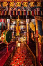 Inside Spituk Gompa Tibetan Buddhist monastery prayer hall with drums