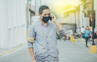 Man with surgical mask calling on the phone