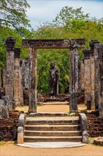 Standing Buddha statue in ancient ruins