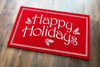 Happy holidays christmas red welcome mat on wood floor background