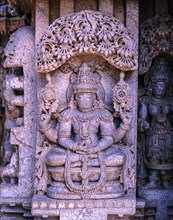 Close up of stone sculpture of dancing Lakshmi in Hoysala architecture at Somnathpur