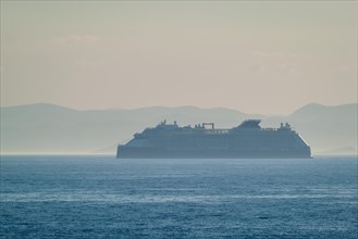 Cruise liner ship silhouette in Mediterranea sea. Aegean sea